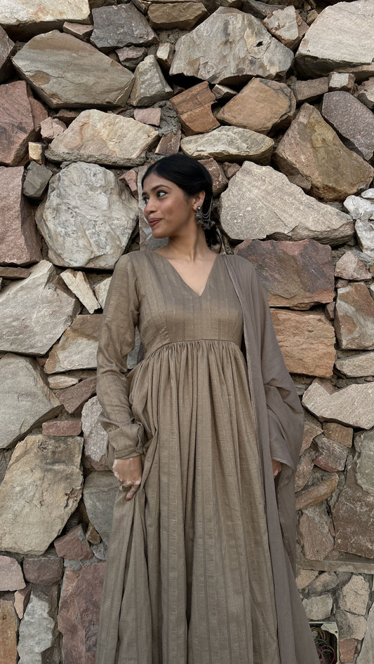 Earthy brown Anarkali with V-neckline, scallop detailing, and chiffon dupatta.