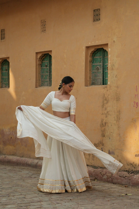 White cotton lehenga set with intricate gota and lappa work. 