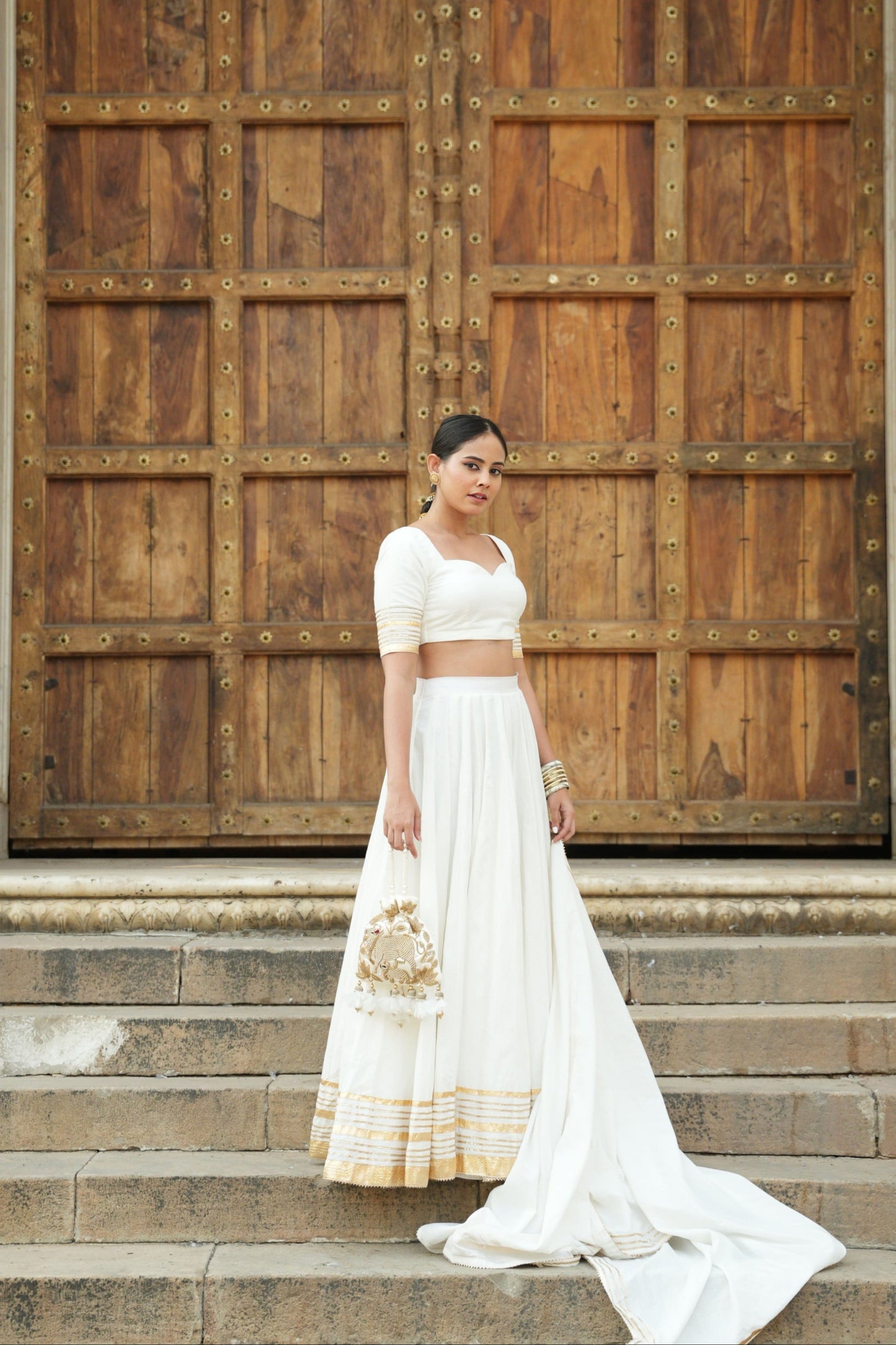White cotton lehenga set with intricate gota and lappa work. 