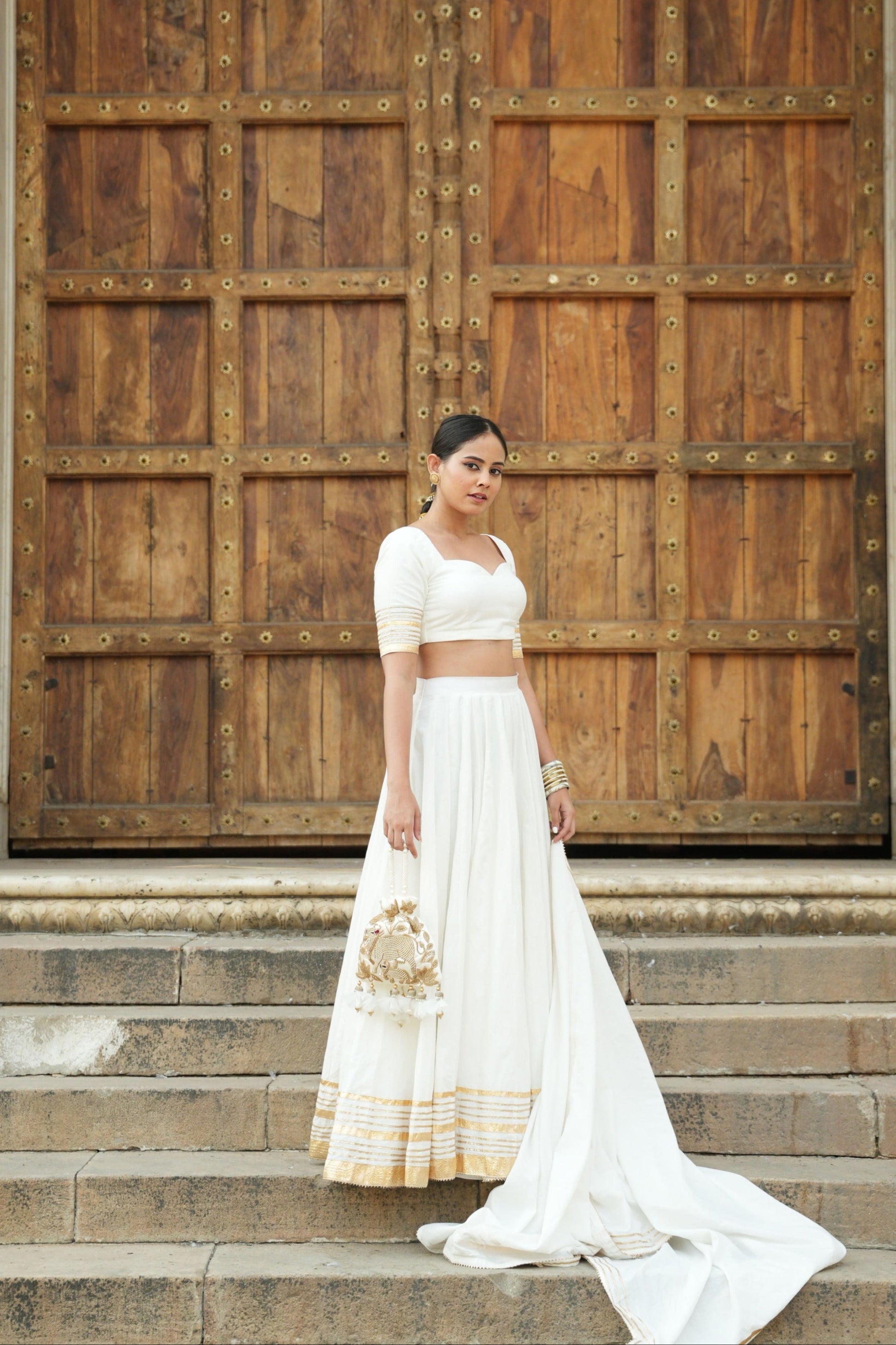 White cotton lehenga set with intricate gota and lappa work. 