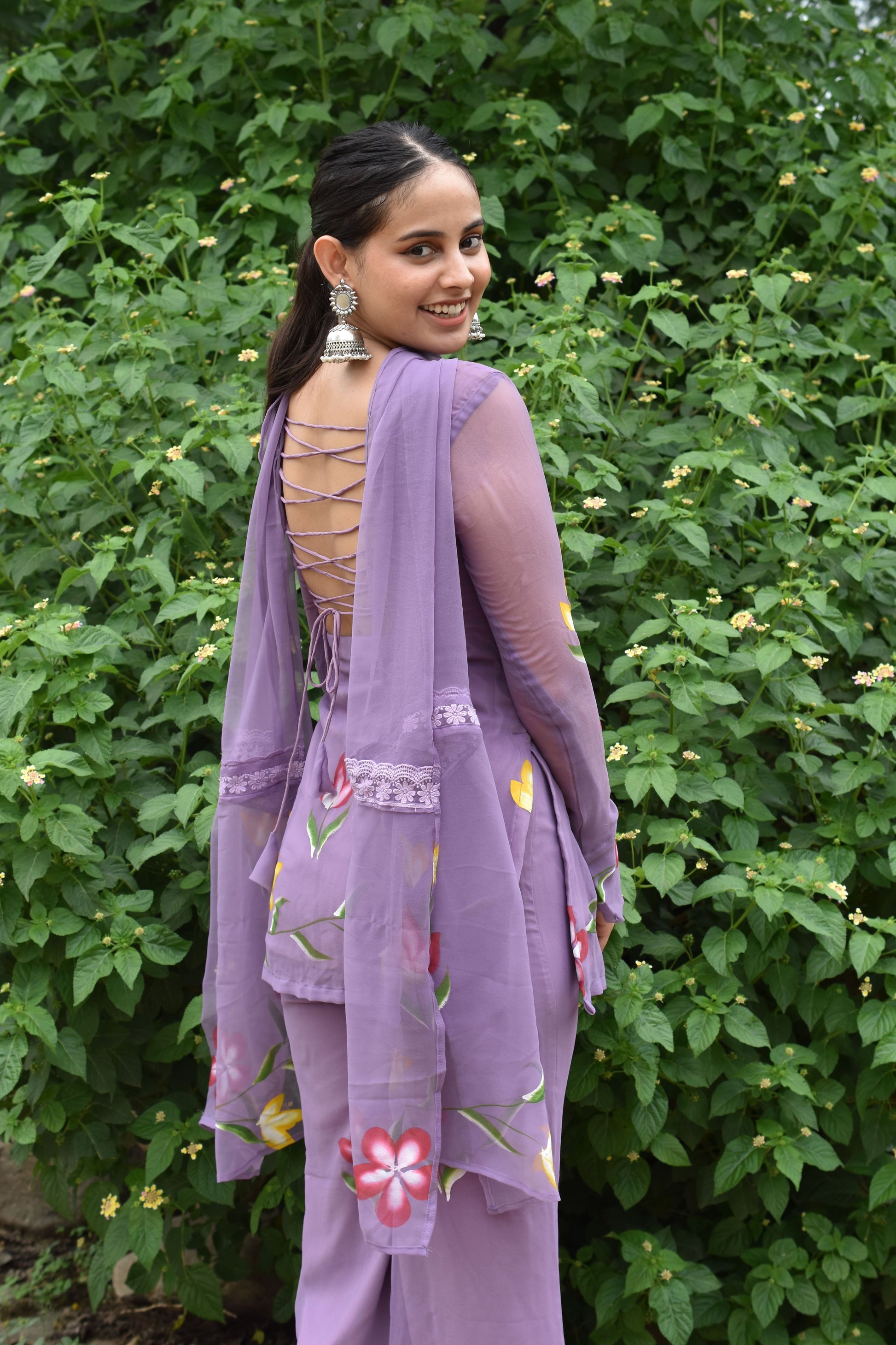 Lavender festive wear suit with deep back design.