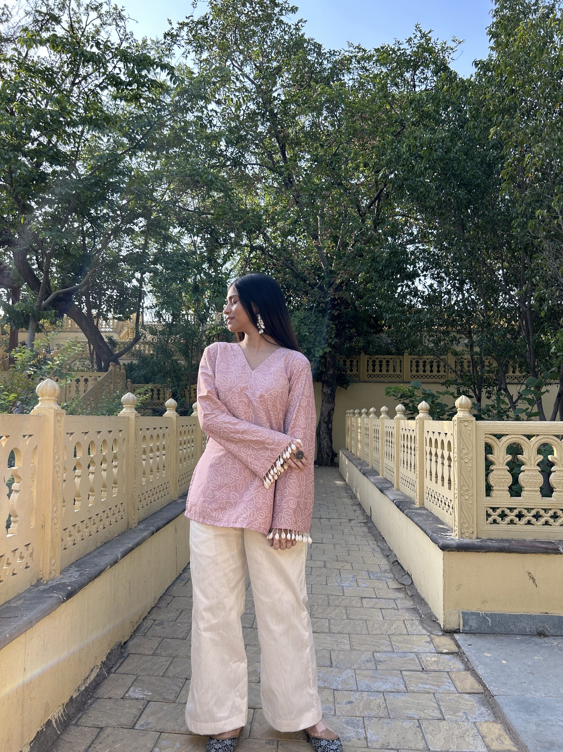 Women’s subtle pink kurta set with dramatic sleeve details and dupion silk pants
