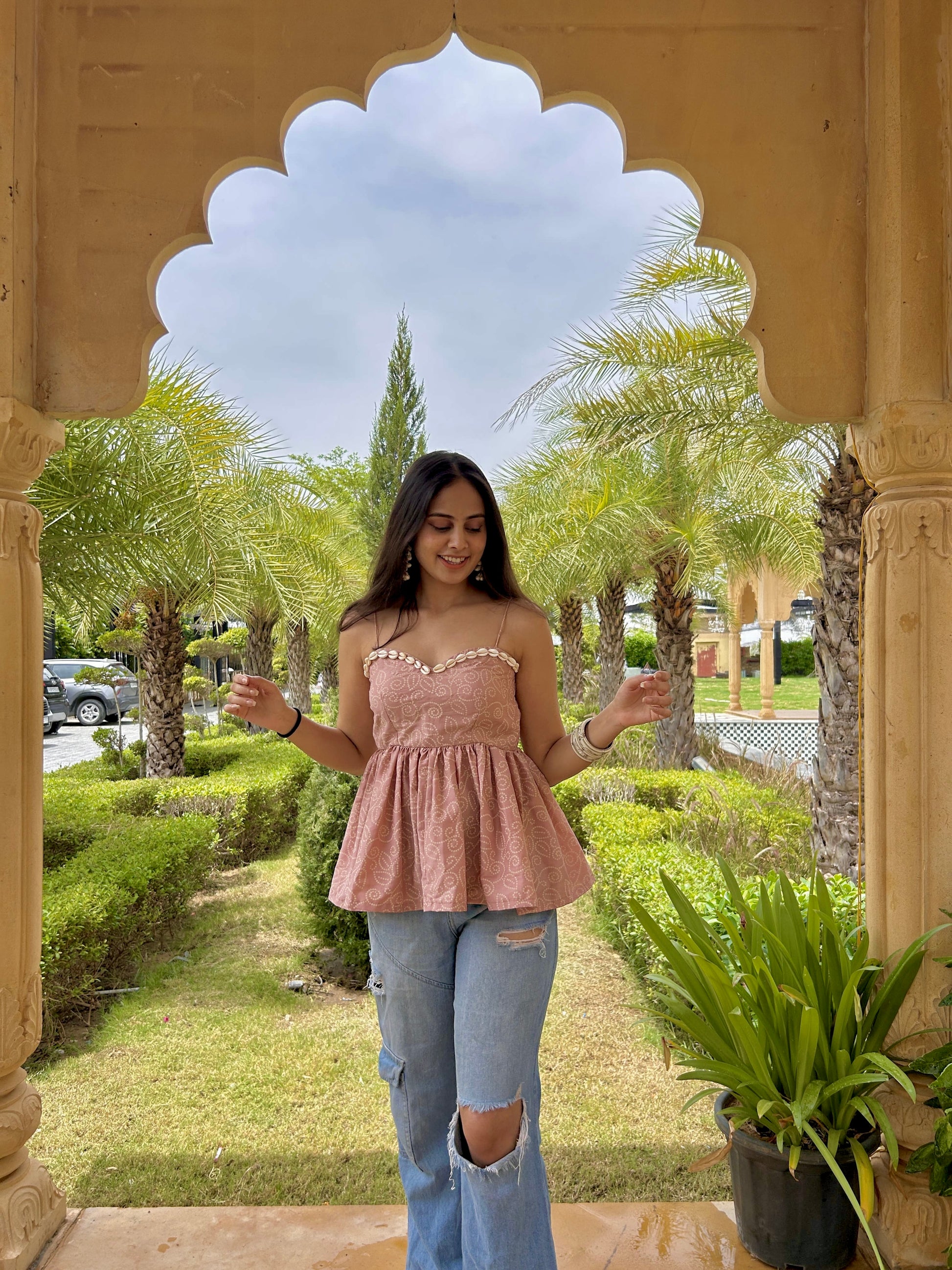 Padded backless peplum top in subtle pink.